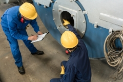 Expert checking the quality of manufactured boilers