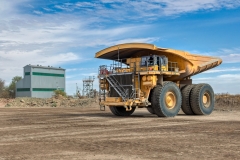 aerial view of mining truck driving on dirt road, in a diamond mine , open pit mine Africa, big tires