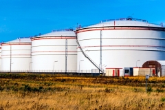 Storage tanks for petroleum products. Equipment refinery . White tanks for petrol and oil in tank farm with blue sky
