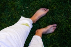 Girl's bare feet in the grass in the open.dirty grass stains on women's pants.daily life dirty stain for wash and clean concept