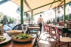 Summer terrace cafe with served table and waiter