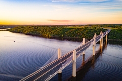 St Croix River bridge over water, encircled by buildings, in the evening
