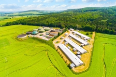 Aerial view over biogas plant and farm in green fields. Renewable energy from biomass. Modern agriculture in Czech Republic and European Union.