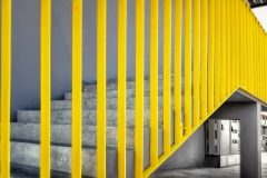 Painted Yellow Guard Rails on a Staircase.