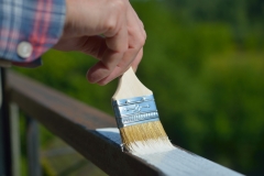 Man painting a guardrail