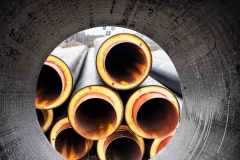 Insulated pipe. Large metal pipes with a plastic sheath at a construction site. Modern pipeline for supplying hot water and heating to a residential area. Close-up.