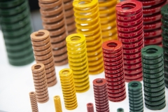 The engineering colourful spring on the white background. The progressive spare part component .