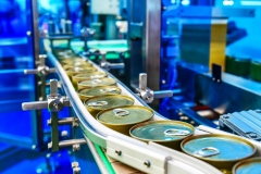 Canned food products on conveyor belt in distribution warehouse.parcels transportation system concept.