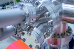 Detail of vacuum equipment with steel flanges bolted to the vessel in laboratory or industrial environment.