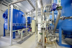 new shiny pipes and large tanks in industrial boiler room