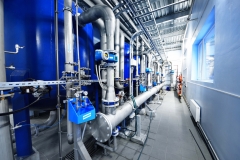 Large blue tanks in a industrial city water treatment boiler room. Wide angle perspective. Special equipment, technology, drinking water supply, chemical modifications, environmental conservation
